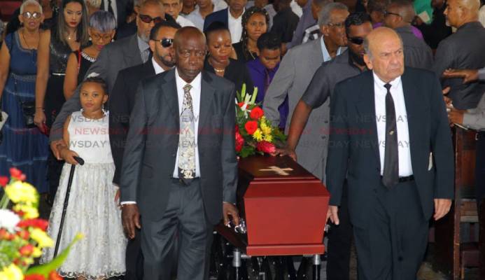 Friends of the late sports journalist Dave Lamy former Fifa vice president Jack Warner (L) and Joe Hadeed (R) carry his casket at the end of Lamy's funeral, at the Holy Trinity Cathedral, Port of Spain. - ROGER JACOB