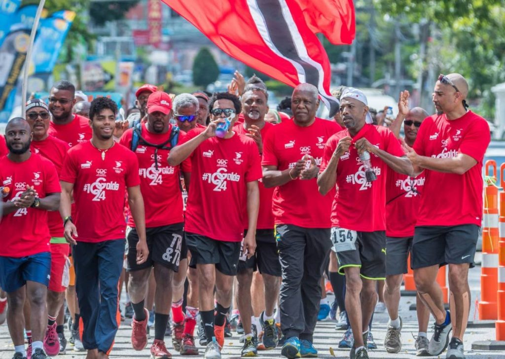 TT Olympic Committee (TTOC) president Brian Lewis, middle, walks the TT International Marathon with supporters, on Sunday. - Melanie Gulston/TTOC