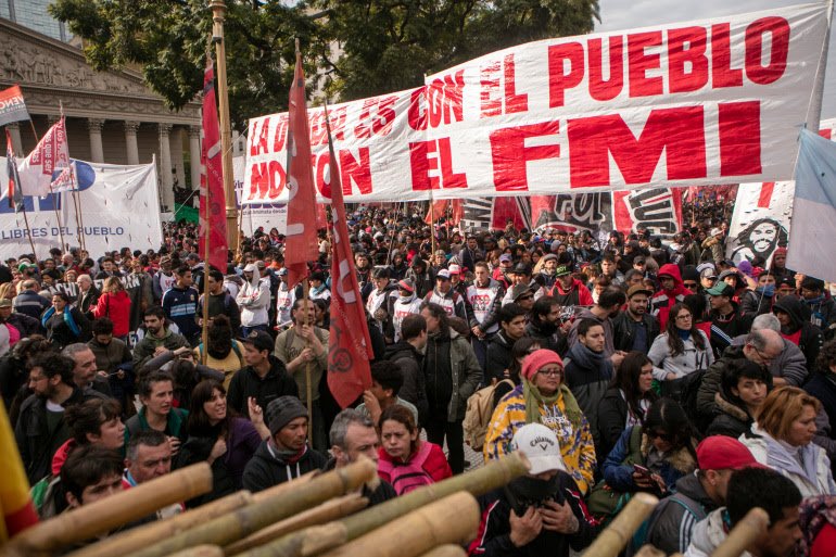 Protesters show a sign that reads 'The debt is with the people, not the IMF' during a demonstration at Plaza de Mayo on August 15, 2019, in Buenos Aires, Argentina [Ricardo Ceppi/ Getty Images]