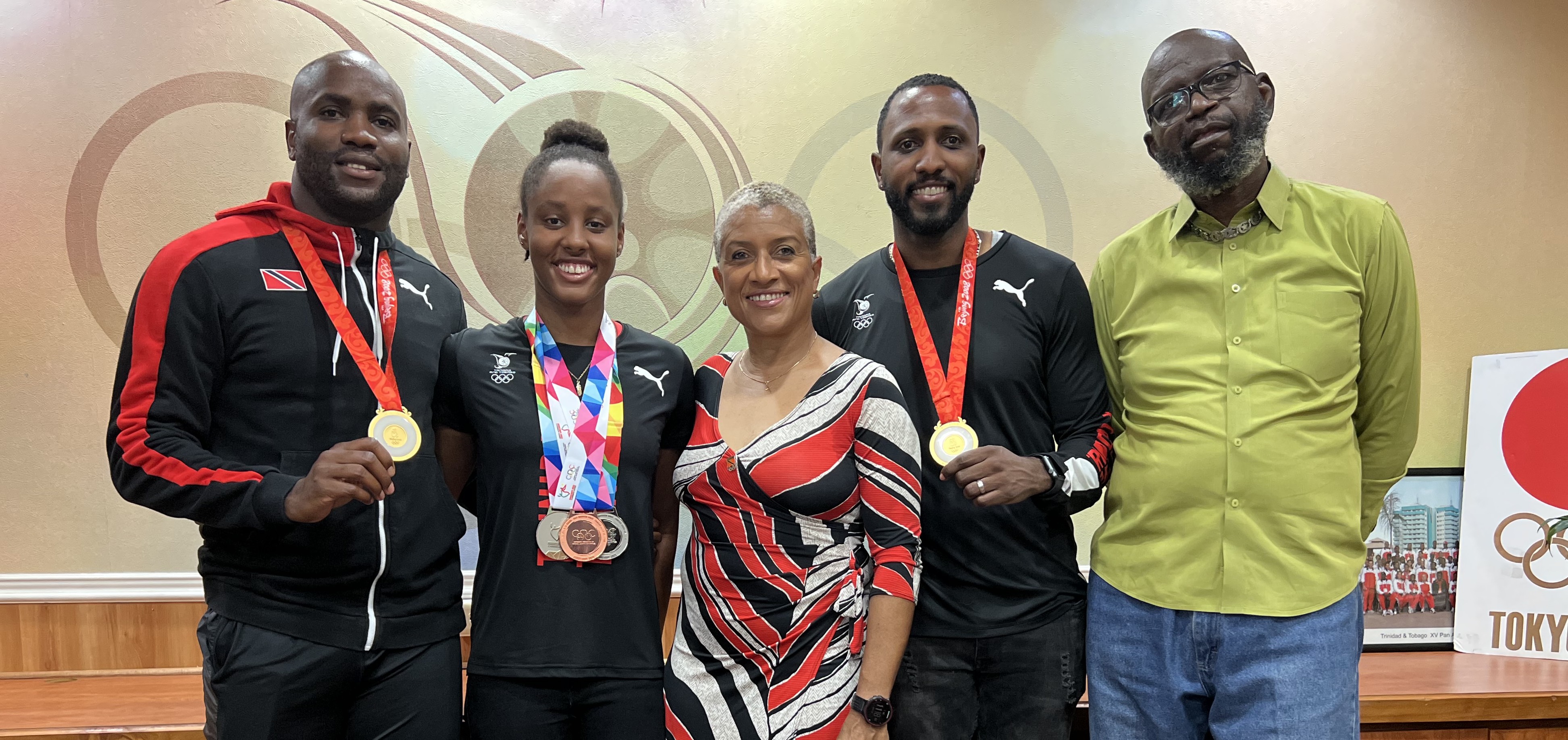 Pictured (from left) are Emmanuel Callender (Olympic Gold Medalist), Jamiah Harley (National Swimmer), Diane Henderson (TTOC/TTCGA President), Richard Thompson (Olympic Gold Medalist) and the father of Aqell Joseph (National Swimmer)