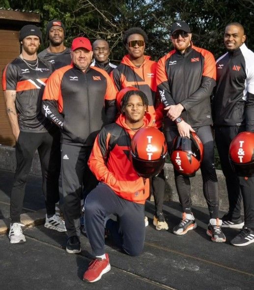 T&T bobsleigh team, from left, Jordan Raymond (coach), Nicholas King, Lee Johnson (head coach), Shakeel John, De Aundre John, Axel Brown, Xaverri Williams, and front (kneeling) Micah Moore. (Image obtained at guardian.co.tt)