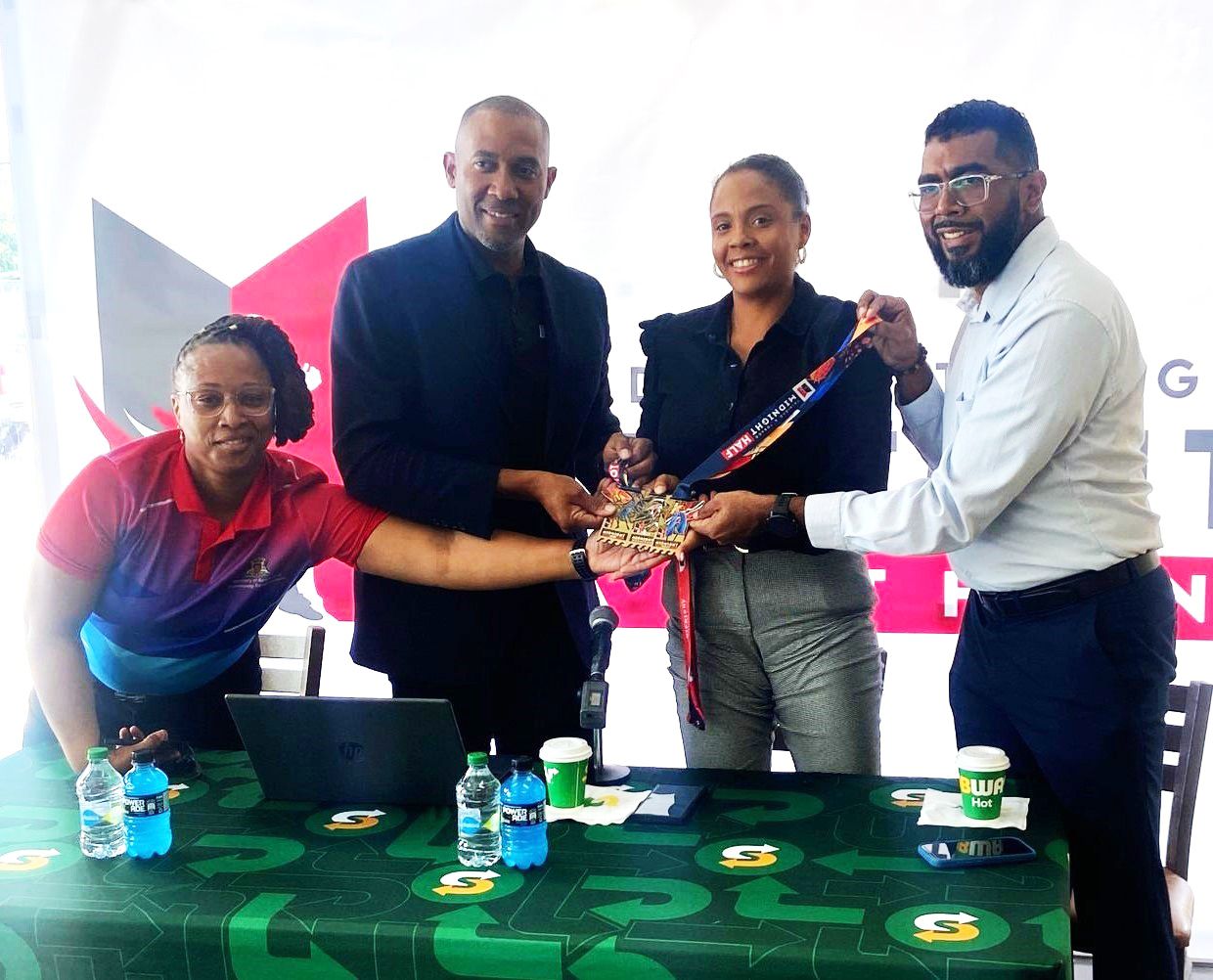 FLASHBACK – Project Administrator for Pink Reign Ministry of Sport and Community Development Latoya Thompson, left, with CEO Bafasports Nigel Bellamy, PRO-TTCG Kyadijah Lamy and Vice Prsident of Subway Johann Mendoza at the launch of Bafasports Midnight Marathon at Subway in Glencoe, in February 2025.  VASHTI SINGH (Image obtained at guardian.co.tt) FLASHBACK – Project Administrator for Pink Reign Ministry of Sport and Community Development Latoya Thompson, left, with CEO Bafasports Nigel Bellamy, PRO-TTCG Kyadijah Lamy and Vice Prsident of Subway Johann Mendoza at the launch of Bafasports Midnight Marathon at Subway in Glencoe, in February 2025.  VASHTI SINGH (Image obtained at guardian.co.tt)