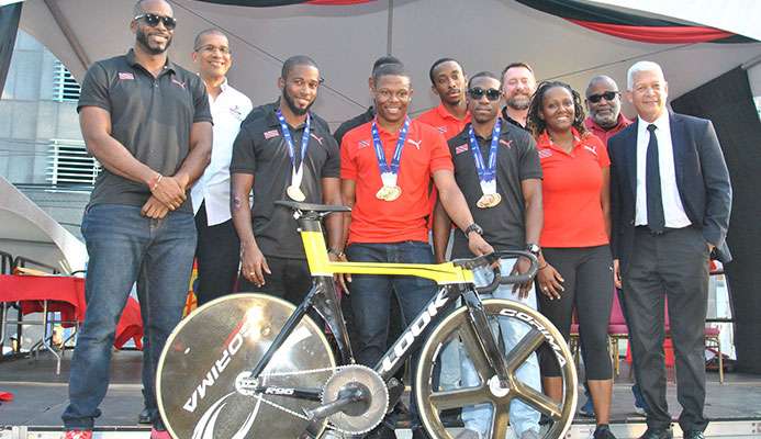 CELEBRATION TIME! Cyclist Nicholas Paul, the fastest man in the world, is surrounded by his national teammates Quincy Alexander, left, Kwesi Browne, 2nd from left, Port-of-Spain Mayor Joel Martinez, right, Antonia Berton, 2nd from right, and Keron Bramble. The team won a gold medal in the team sprint event, while Paul set a new world record in the flying 200meters event at the just concluded Elite Pan American Continental Championship in Bolivia and was celebrated on the Brian Lara Promenade in the Capital City on Saturday. CELEBRATION TIME! Cyclist Nicholas Paul, the fastest man in the world, is surrounded by his national teammates Quincy Alexander, left, Kwesi Browne, 2nd from left, Port-of-Spain Mayor Joel Martinez, right, Antonia Berton, 2nd from right, and Keron Bramble. The team won a gold medal in the team sprint event, while Paul set a new world record in the flying 200meters event at the just concluded Elite Pan American Continental Championship in Bolivia and was celebrated on the Brian Lara Promenade in the Capital City on Saturday.