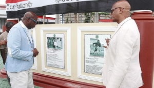 1976 Olympic Gold Medallist Hasely Crawford, left, view the Wall of Fame with San Fernando Mayor Junia Regrello after the unveiling ceremony at the Harris Promenade Bandstand in San Fernando, yesterday. TONY HOWELL 1976 Olympic Gold Medallist Hasely Crawford, left, view the Wall of Fame with San Fernando Mayor Junia Regrello after the unveiling ceremony at the Harris Promenade Bandstand in San Fernando, yesterday. TONY HOWELL